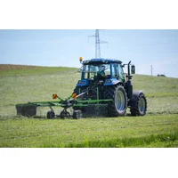 Mowing grass with an LS tractor and a Hofman rake
